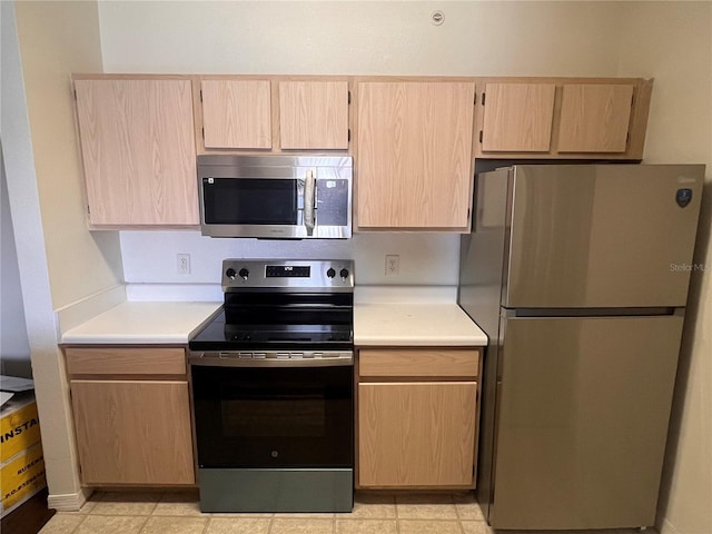 5459 Vineland Rd Unit 4310, Orlando, FL 32811 - kitchen with appliances with stainless steel finishes, light countertops, and light brown cabinetry