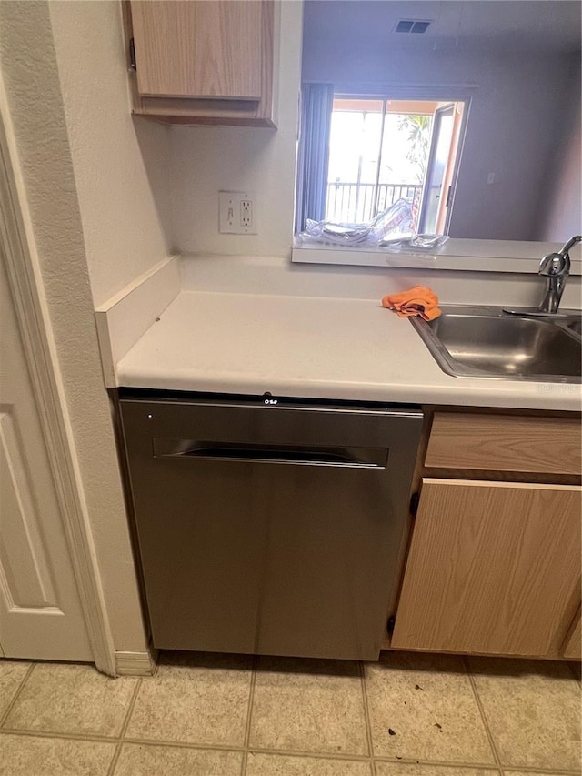 5459 Vineland Rd Unit 4310, Orlando, FL 32811 - kitchen featuring stainless steel dishwasher, light countertops, a sink, and light tile patterned floors