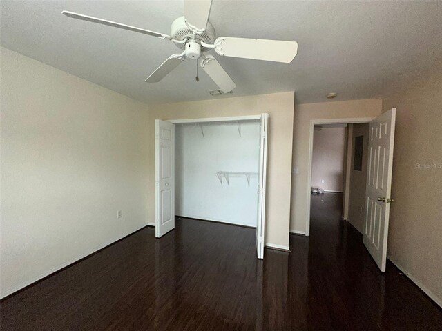 5459 Vineland Rd Unit 4310, Orlando, FL 32811 - unfurnished bedroom with wood finished floors, ceiling fan, baseboards, and a closet
