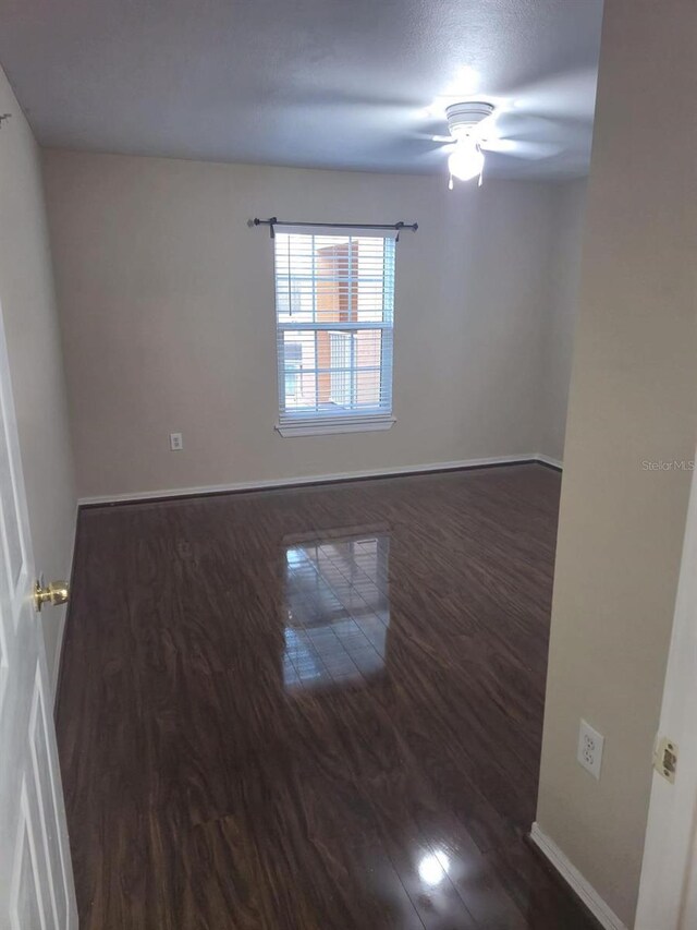 5459 Vineland Rd Unit 4310, Orlando, FL 32811 - empty room with wood finished floors, baseboards, and a ceiling fan