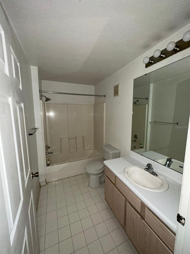 5459 Vineland Rd Unit 4310, Orlando, FL 32811 - bathroom with tile patterned flooring, vanity, bathing tub / shower combination, toilet, and a textured ceiling