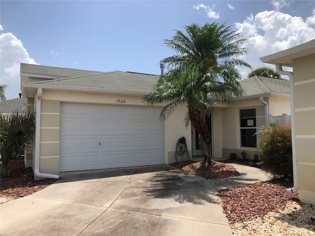 1524 Conway Ct, The Villages, FL 32162 - view of front of home with driveway, a garage, stucco siding, and roof with shingles