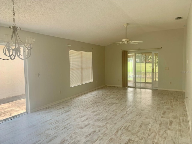 1524 Conway Ct, The Villages, FL 32162 - spare room featuring a chandelier, a textured ceiling, light wood-type flooring, ceiling fan, and baseboards