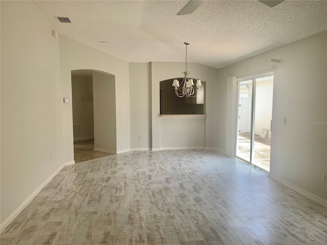 1524 Conway Ct, The Villages, FL 32162 - unfurnished room with arched walkways, a chandelier, a textured ceiling, wood finished floors, and baseboards