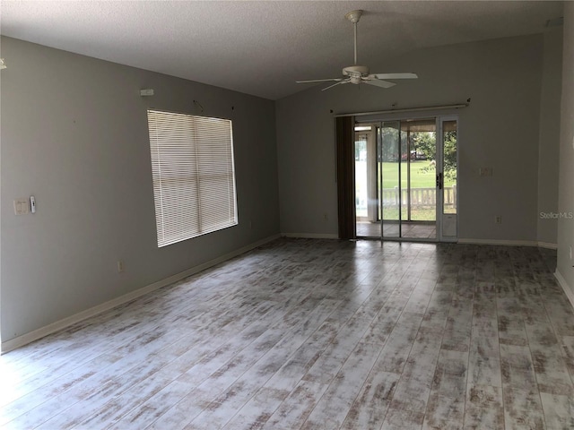 1524 Conway Ct, The Villages, FL 32162 - spare room with ceiling fan, wood finished floors, lofted ceiling, a textured ceiling, and baseboards