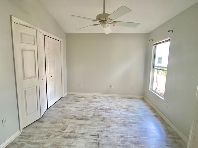 1524 Conway Ct, The Villages, FL 32162 - unfurnished bedroom with multiple windows, light wood finished floors, a closet, vaulted ceiling, and a ceiling fan