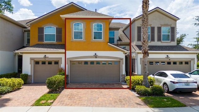3508 Brighton Park Cir, Belle Isle, FL 32812 - view of front of property with a garage, stucco siding, and decorative driveway