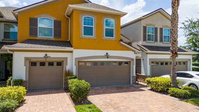 3508 Brighton Park Cir, Belle Isle, FL 32812 - view of front of house with an attached garage, stucco siding, and decorative driveway