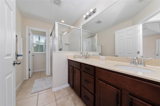3508 Brighton Park Cir, Belle Isle, FL 32812 - bathroom with double vanity, a stall shower, tile patterned floors, and baseboards