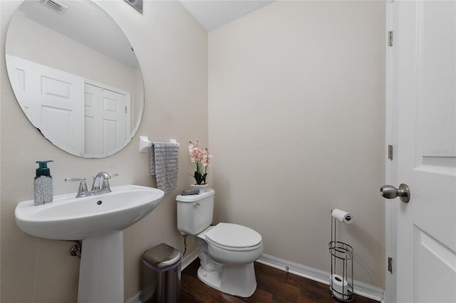 3508 Brighton Park Cir, Belle Isle, FL 32812 - bathroom with toilet, baseboards, and wood finished floors