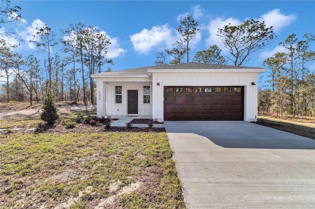 23430 SW Neptune Blvd, Dunnellon, FL 34431 - view of front facade featuring driveway, board and batten siding, an attached garage, and roof with shingles