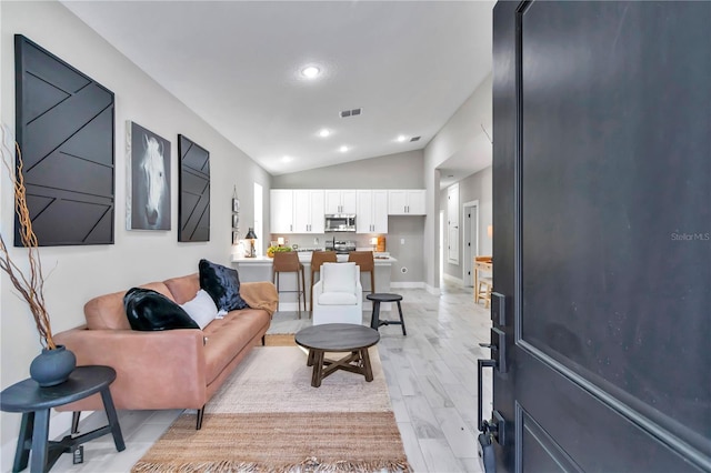 23430 SW Neptune Blvd, Dunnellon, FL 34431 - living room featuring vaulted ceiling, baseboards, and recessed lighting