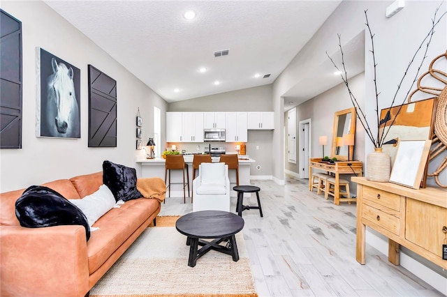 23430 SW Neptune Blvd, Dunnellon, FL 34431 - living area featuring lofted ceiling, light wood-style floors, recessed lighting, and baseboards