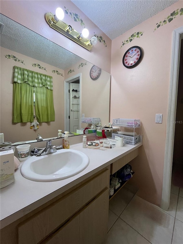 2765 Montego Bay Blvd, Kissimmee, FL 34746 - bathroom featuring a textured ceiling, tile patterned floors, and vanity