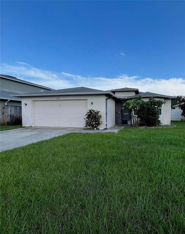 2765 Montego Bay Blvd, Kissimmee, FL 34746 - view of front of house with a garage, driveway, and stucco siding