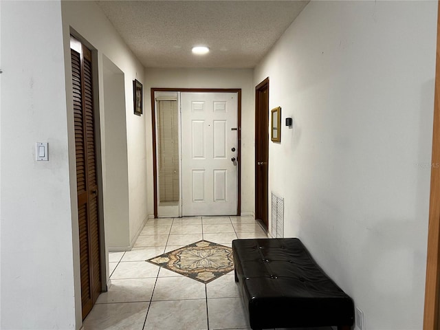 2765 Montego Bay Blvd, Kissimmee, FL 34746 - doorway to outside with light tile patterned flooring and a textured ceiling