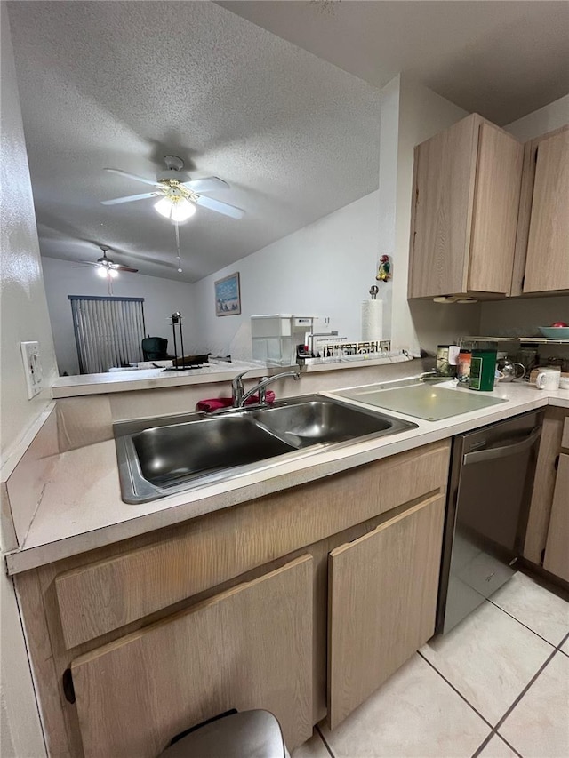 2765 Montego Bay Blvd, Kissimmee, FL 34746 - kitchen with light brown cabinets, light countertops, stainless steel dishwasher, light tile patterned floors, and a textured ceiling