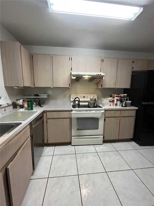 2765 Montego Bay Blvd, Kissimmee, FL 34746 - kitchen with light brown cabinetry, white range with electric cooktop, light countertops, and freestanding refrigerator