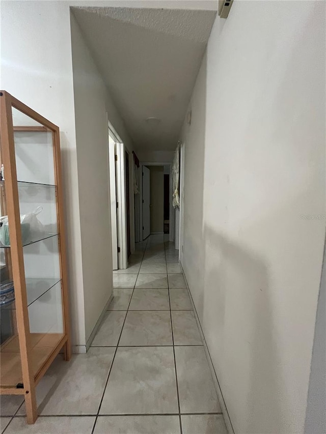2765 Montego Bay Blvd, Kissimmee, FL 34746 - corridor featuring light tile patterned floors and baseboards