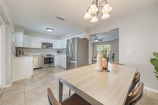 9494 Lake Lotta Cir, Gotha, FL 34734 - dining space featuring a chandelier, light tile patterned floors, and a ceiling fan