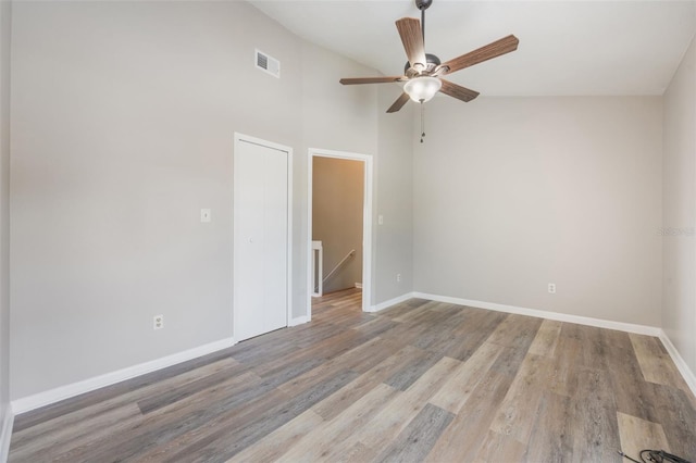 9494 Lake Lotta Cir, Gotha, FL 34734 - empty room featuring ceiling fan, light wood-type flooring, and a towering ceiling