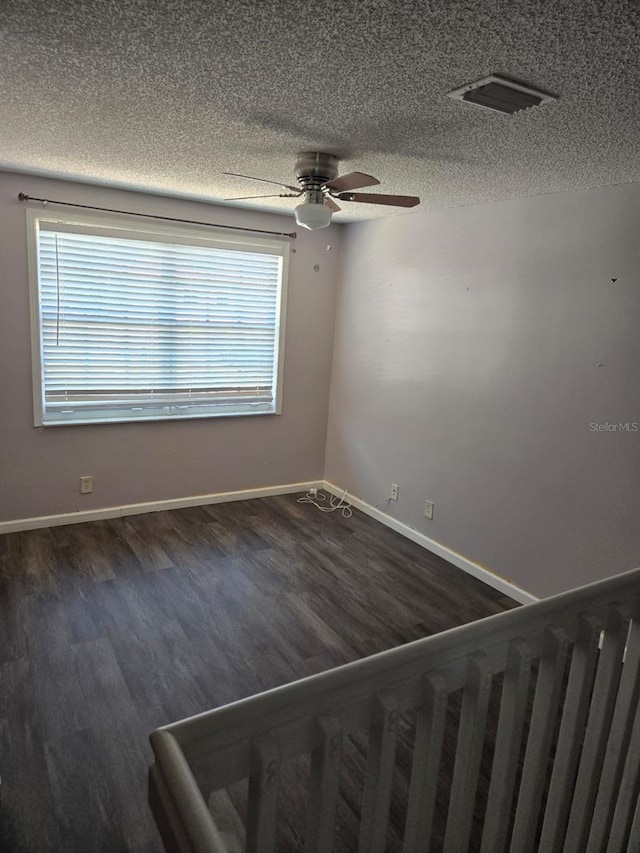 3869 Sienna Greens Ter, Lauderhill, FL 33319 - unfurnished room with dark wood-style floors, a textured ceiling, and a ceiling fan