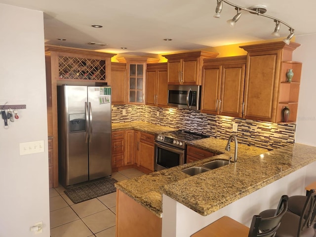 3869 Sienna Greens Ter, Lauderhill, FL 33319 - kitchen with stainless steel appliances, brown cabinets, a peninsula, and recessed lighting
