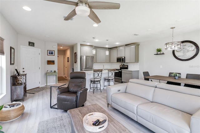 378 Cape Honeysuckle Pl, Sanford, FL 32771 - living area featuring ceiling fan, recessed lighting, light wood-style flooring, and a chandelier