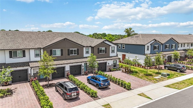 378 Cape Honeysuckle Pl, Sanford, FL 32771 - multi unit property with driveway, an attached garage, stucco siding, a residential view, and stone siding