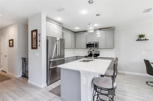 378 Cape Honeysuckle Pl, Sanford, FL 32771 - kitchen featuring stainless steel appliances, light countertops, light wood-type flooring, gray cabinetry, and recessed lighting