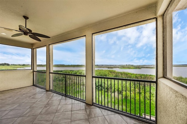 15344 Johns Lake Pointe Blvd, Winter Garden, FL 34787 - unfurnished sunroom with a water view, ceiling fan, and tile patterned flooring
