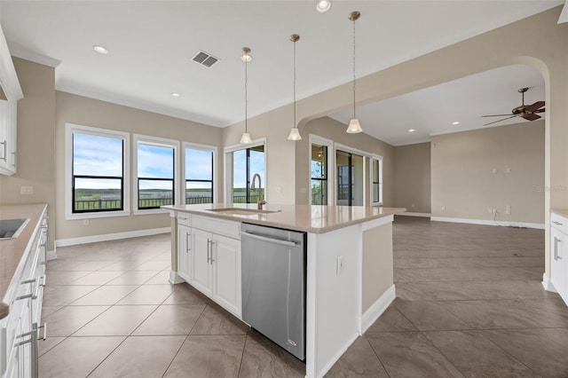 15344 Johns Lake Pointe Blvd, Winter Garden, FL 34787 - kitchen featuring stainless steel dishwasher, arched walkways, crown molding, recessed lighting, and light countertops