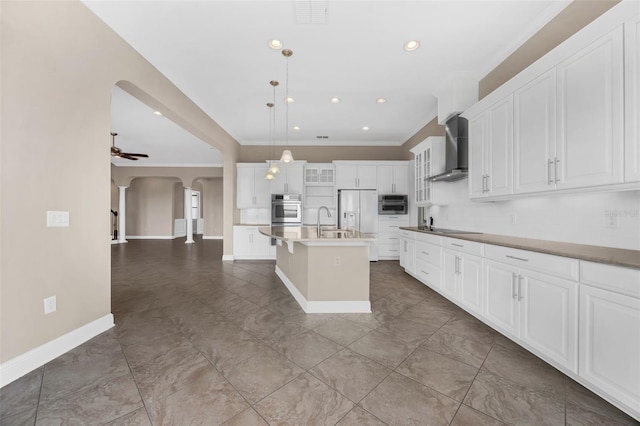 15344 Johns Lake Pointe Blvd, Winter Garden, FL 34787 - kitchen featuring wall chimney range hood, arched walkways, white fridge with ice dispenser, black electric stovetop, and crown molding