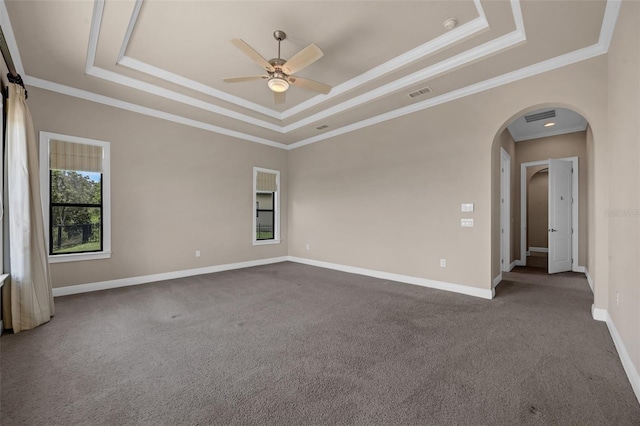 15344 Johns Lake Pointe Blvd, Winter Garden, FL 34787 - carpeted spare room with a tray ceiling, ornamental molding, ceiling fan, and arched walkways