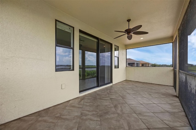 15344 Johns Lake Pointe Blvd, Winter Garden, FL 34787 - unfurnished sunroom featuring healthy amount of natural light, a textured wall, and tile patterned flooring