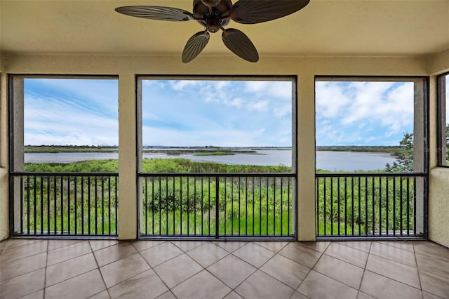 15344 Johns Lake Pointe Blvd, Winter Garden, FL 34787 - unfurnished sunroom with a water view, tile patterned flooring, and plenty of natural light