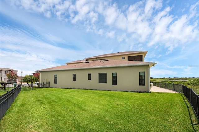 15344 Johns Lake Pointe Blvd, Winter Garden, FL 34787 - back of property featuring stucco siding, a fenced backyard, and a shingled roof