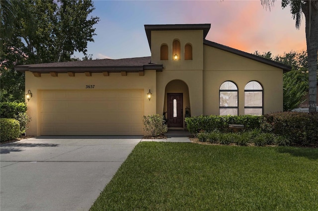 3637 Foxchase Dr, Clermont, FL 34711 - mediterranean / spanish-style home featuring stucco siding, an attached garage, driveway, and a lawn