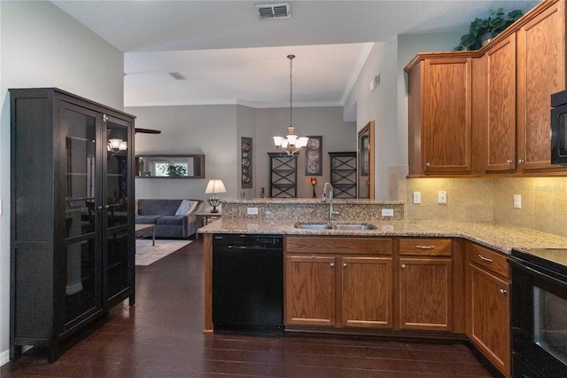 3637 Foxchase Dr, Clermont, FL 34711 - kitchen featuring black appliances, a peninsula, a chandelier, light stone counters, and decorative backsplash