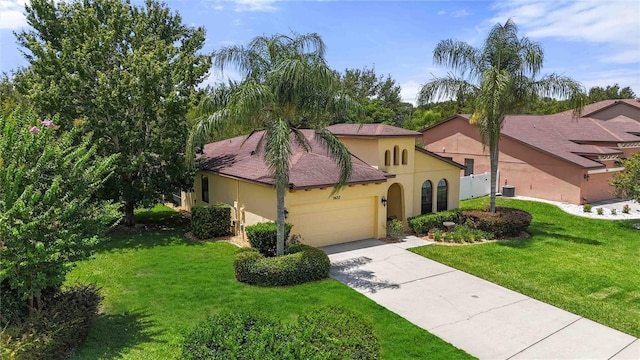 3637 Foxchase Dr, Clermont, FL 34711 - mediterranean / spanish-style home featuring stucco siding, an attached garage, concrete driveway, and a front yard