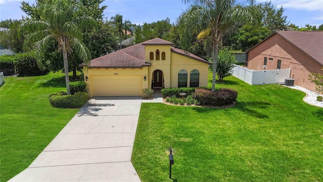 3637 Foxchase Dr, Clermont, FL 34711 - mediterranean / spanish-style home with a garage, stucco siding, and driveway