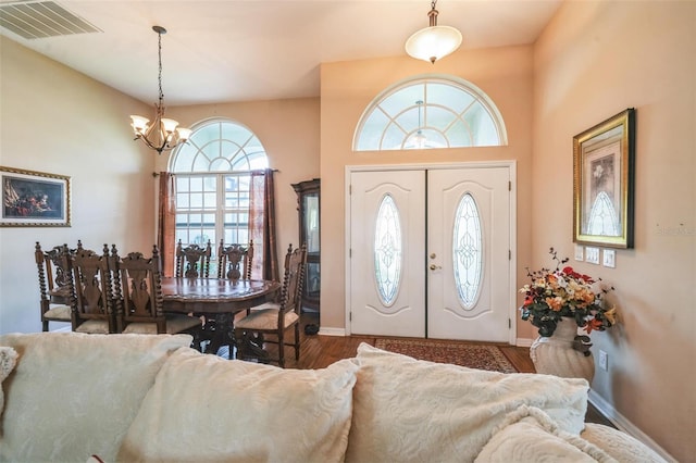 742 Seneca Trl, Saint Cloud, FL 34772 - foyer entrance with a chandelier, wood finished floors, and baseboards