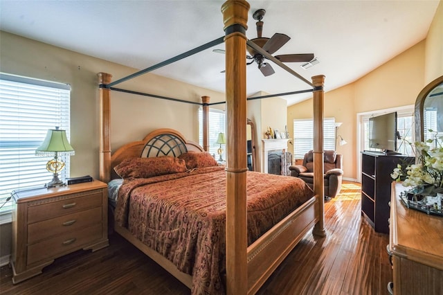 742 Seneca Trl, Saint Cloud, FL 34772 - bedroom featuring multiple windows, dark wood finished floors, vaulted ceiling, a ceiling fan, and a fireplace