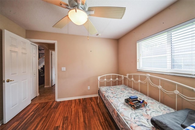 742 Seneca Trl, Saint Cloud, FL 34772 - bedroom with multiple windows, dark wood-type flooring, ceiling fan, and baseboards