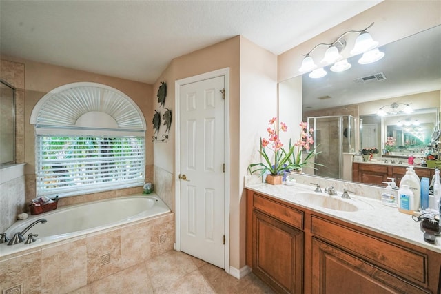 742 Seneca Trl, Saint Cloud, FL 34772 - bathroom featuring a stall shower, a garden tub, vanity, and tile patterned flooring
