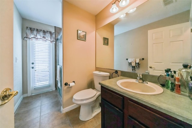742 Seneca Trl, Saint Cloud, FL 34772 - bathroom featuring a stall shower, vanity, baseboards, tile patterned flooring, and toilet
