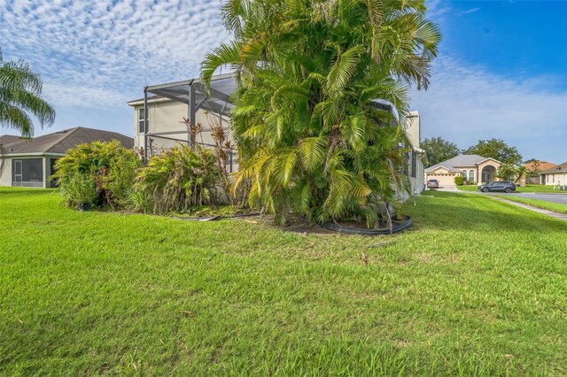 742 Seneca Trl, Saint Cloud, FL 34772 - view of side of home featuring a yard and a lanai