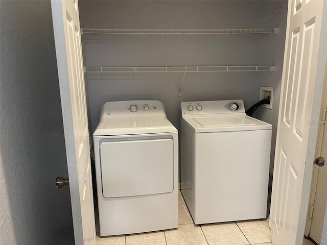 6100 Stevenson Dr Unit 207, Orlando, FL 32835 - laundry area featuring washing machine and dryer and light tile patterned floors