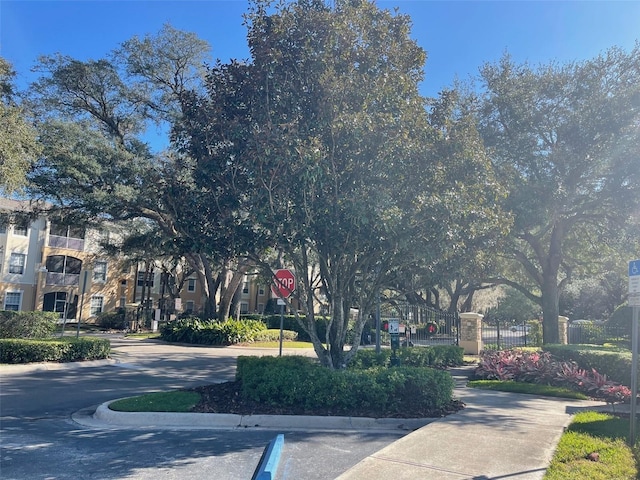 6100 Stevenson Dr Unit 207, Orlando, FL 32835 - view of asphalt road with traffic signs and curbs