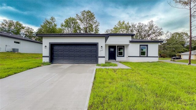2498 W Magenta Dr, Citrus Springs, FL 34434 - view of front of property with stucco siding, a garage, driveway, and a front lawn